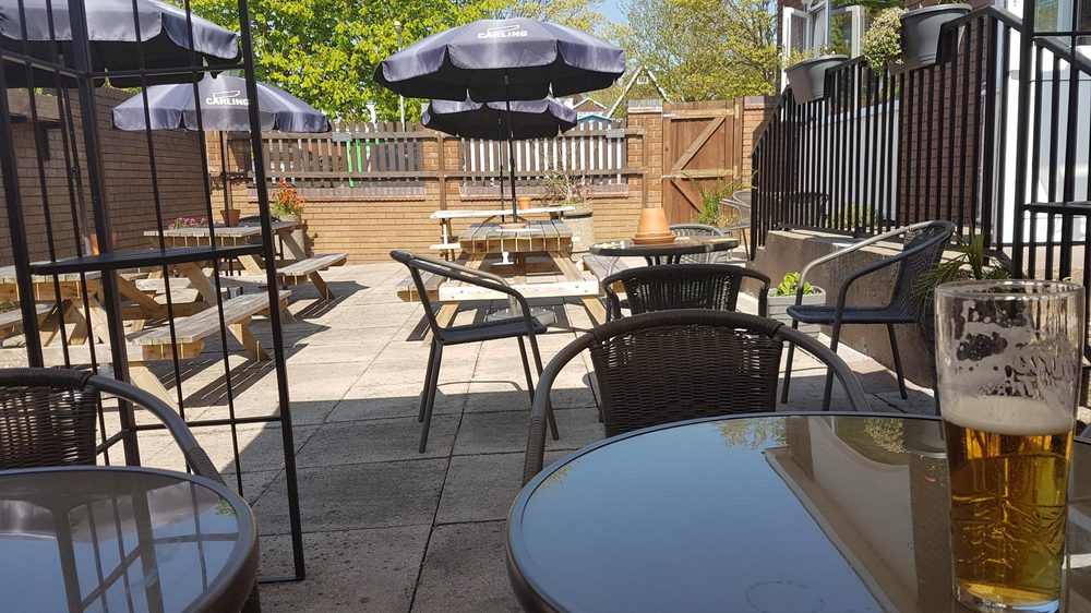 Beer garden with parasols and a cold pint on a sunny day