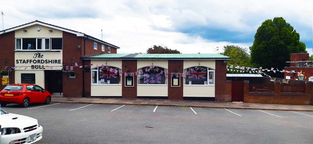 The Staffordshire Bull pub exterior with Union Jack bunting and free parking in front